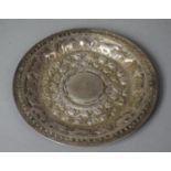 An Indian White Metal Plate with Repousse Decoration Depicting Elephants, Cows and Birds etc, 17.5cm