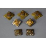A Collection of Six Military Embroidered and Metal Badges
