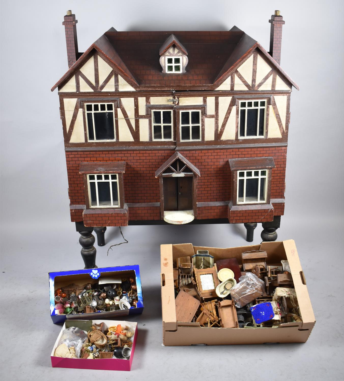 A Late 19th/Early 20th Century Dolls House, The Cotswold, on Ebonized Wooden Support Complete with