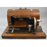 A Cased Spinney Manual Sewing Machine