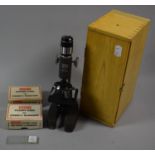 A Cased Sound and Science Student Microscope, Complete with Specimen Slides by Merit