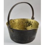 A Late 19th Century Brass Jam Kettle with Iron Loop Handle, 31.5cms Diameter