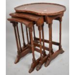 A Mahogany Nest of Kidney Shaped Pie Crust Topped Tables with Turned Spindle Supports, 55cms Wide