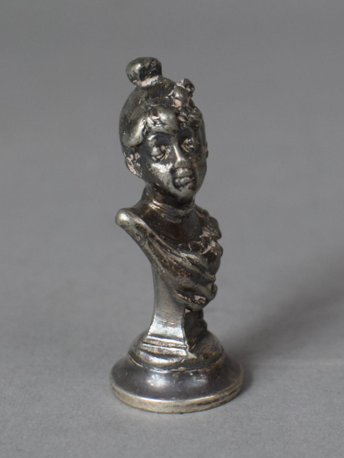 A Small White Metal Seal in the form of a Maiden, Daisy, 8cms High