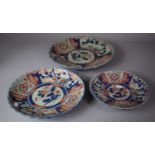 A Collection of Three Oriental Reproduction Imari Chargers of Graduated Size, The Largest 35cms