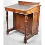 An Edwardian Mahogany Davenport with Two Inner Drawers and Side Panel Hiding Four Drawers, Raised