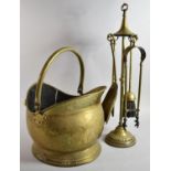 A Brass Helmet Shaped Coal Scuttle Together with a Brass Fire Companion Set