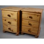 A Pair of Pine Three Drawer Bedside Cupboards