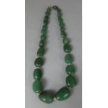 A String of Jade/Aventurine Beads with 9ct Gold Clasp, 40cm long