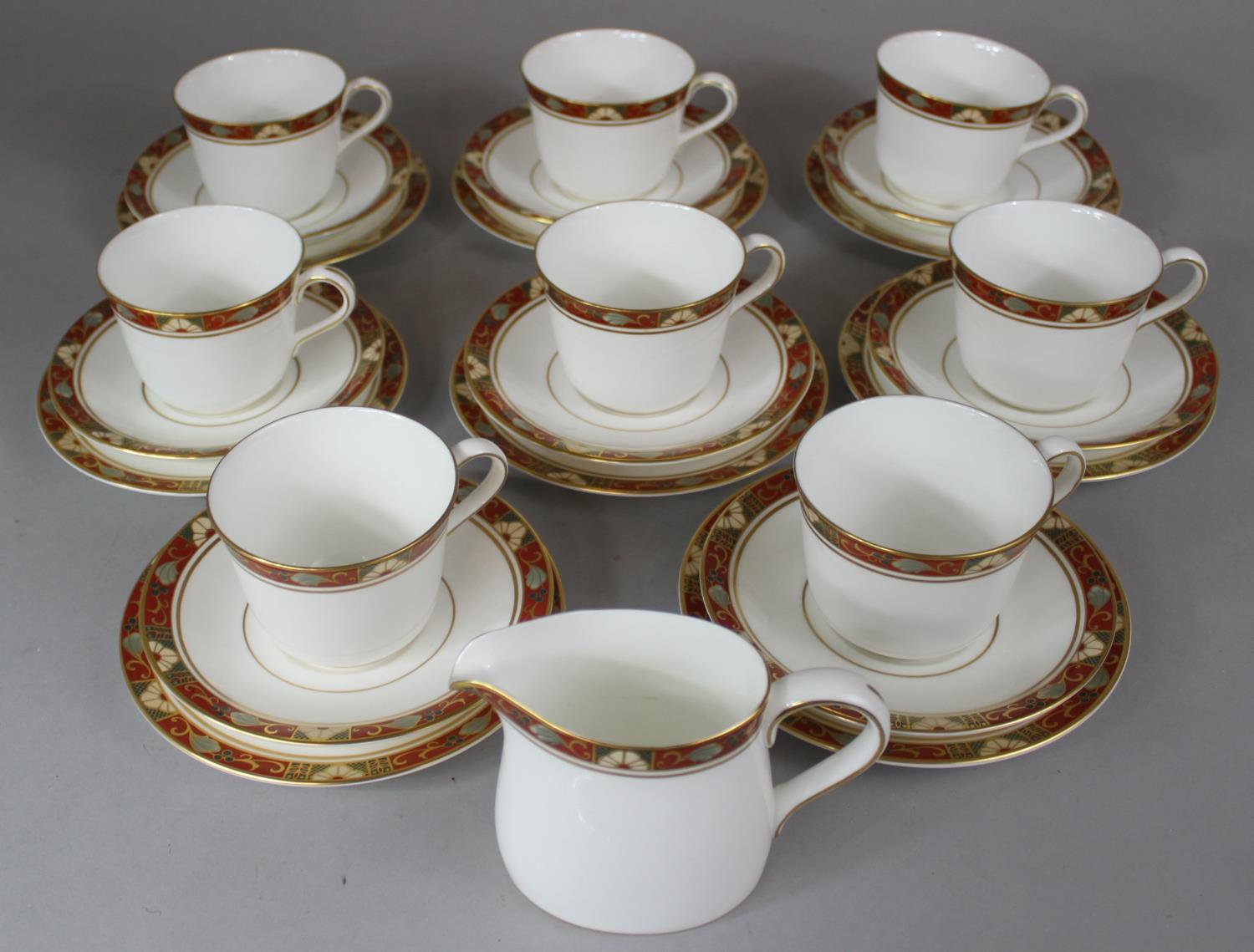 A Royal Crown Derby Cloisonne Tea Set Comprising Eight Trios and a Cream Jug