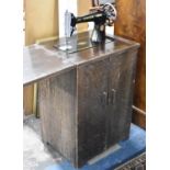 An Edwardian Oak Cased Singer Treadle Sewing Machine