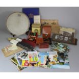A Tray of Sundries to include Vintage Sonor Tambourine, Various Postcards, Darts, Printed
