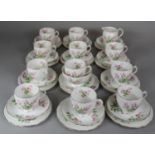 A Roslyn China Tea Set comprising Eleven Cups, Twelve Side Plates, Twelve Saucers, Cream and Sugar