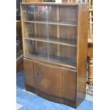 A Mid 20th Century Breakfront Mahogany Bookcase, with Glazed Shelf Top and Cupboard Base, "Presented