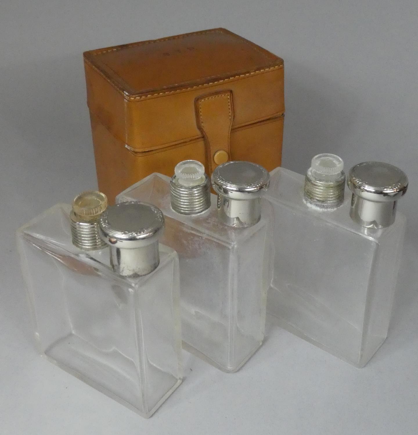 A Nice Quality Leather Cased Set of Three Glass Flasks with Silver Plated Tops, Hinged Lid - Image 2 of 2