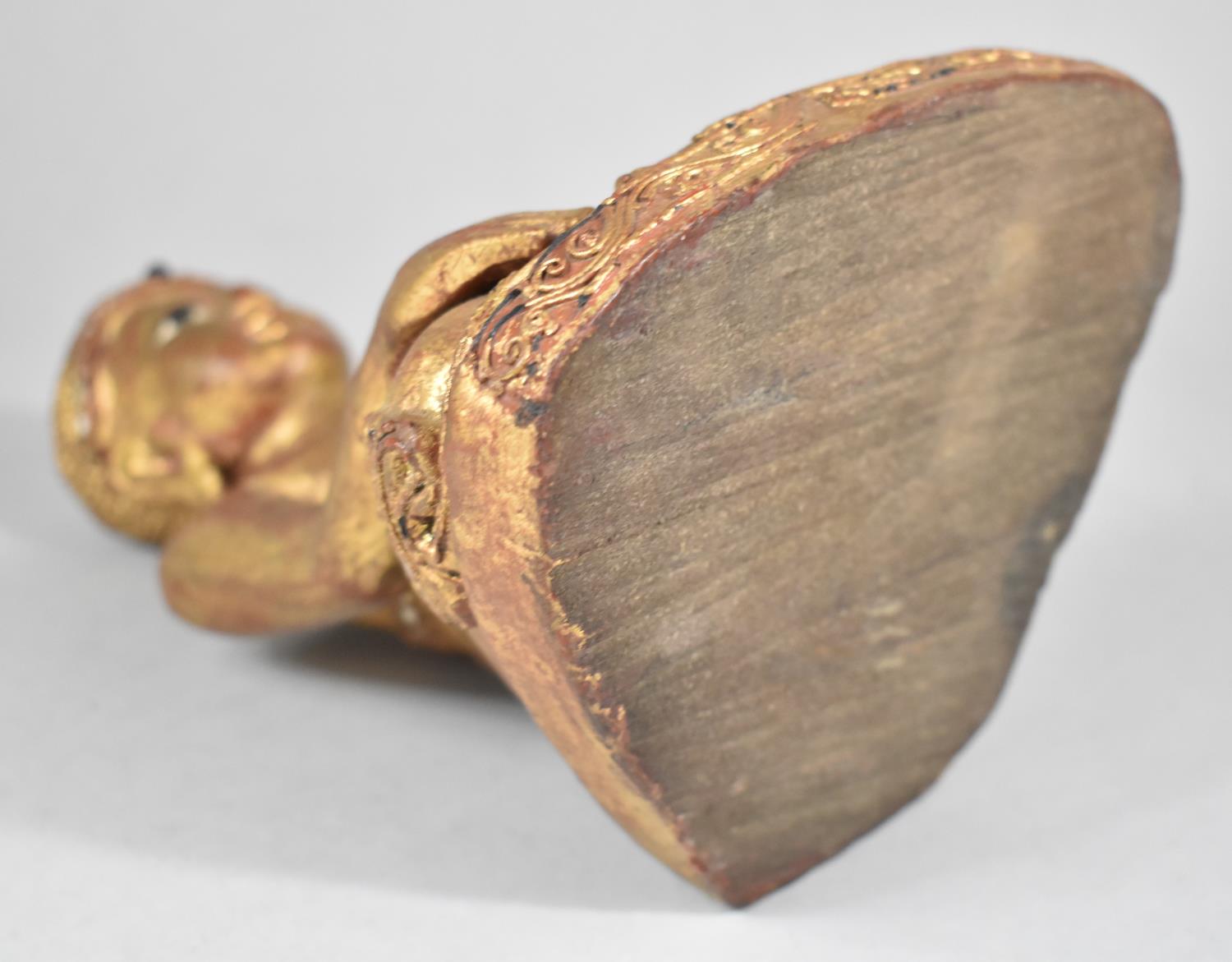 A Carved Wooden Gilt Decorated Study of Seated Buddha with Inlaid Mirror Fragments, 22cm high - Image 2 of 2