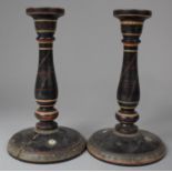 A Pair of Turned Oriental Lacquered Candlesticks, both Have Splits to Base, 24cm high