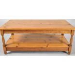 A Rectangular Two Tier Pine Coffee Table with Turned Supports, 106cm wide