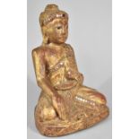 A Carved Wooden Gilt Decorated Study of Seated Buddha with Inlaid Mirror Fragments, 22cm high