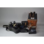 A Collection of Vintage Cameras and Binoculars