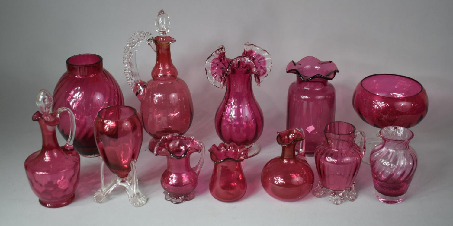 A Collection of 12 Pieces of Cranberry Glass to include Cordial Jug, Vases, Ovoid Vase Etc