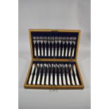A Cased Set of Twelve Mother of Pearl Handled Fish Knives and Forks