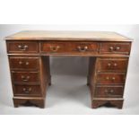 A Kneehole Mahogany Desk with Tooled Leather Top, Requiring Some Attention, 122cm wide