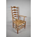 A Late 19th Century Rush Seated Ladder Back Kitchen Armchair