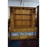 A Crossbanded Light Oak Three Drawer Dresser with Pot Shelf on Turned Supports and Having Raised