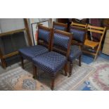A Set of Four Upholstered Edwardian Oak Framed Dining Chairs with Carved Top Rails