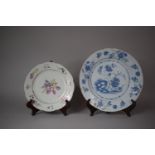 An Oriental Tin Glazed Floral Painted Plate Together with a Tin Glazed Blue and White Plate, Glued