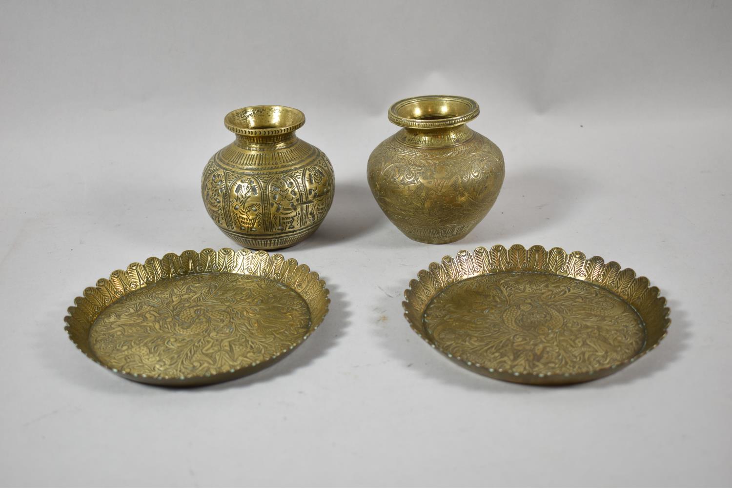 Two Indian Brass Vases and Pair of Lotus Bordered Circular Dishes Decorated with Ganesha and Other