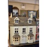A Modern Dolls House Complete with Furniture, 62cm wide