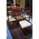 An Edwardian Oak Armchair, Three Cane Seated Bedroom Chairs and an Aesthetic Nursing Chair