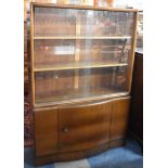 A Mid 20th Century Walnut Glazed Bookcase with Sliding Doors Over Cupboard Base, Presented 1955,