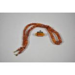 A Single Amber Mounted White Metal Cufflink and Stringer on Amber Chipped Beads, 52cm Long