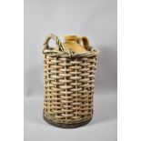 A Honey Glazed Stoneware Bottle for Wyld & Co., Bristol in Wicker Carrying Basket, 41cm High