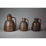 A Set of Indian Copper Jugs with Repousse Work Decoration Depicting Figures Riding Horse, Camel,