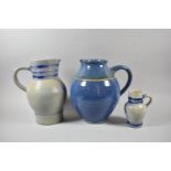 Two German Glazed Stoneware Jugs and a Blue Glazed Stoneware Jug