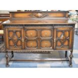 An Edwardian Oak Sideboard with Raised Gallery Back, Turned Supports, Two Centre Drawers and