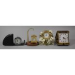 A Travelling Alarm Clock, Two Miniature Brass and Enamelled Mantle Clocks, Stand etc