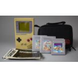 A Vintage Nintendo Gameboy with Super Mario Land II and Disney Tail Spins Games