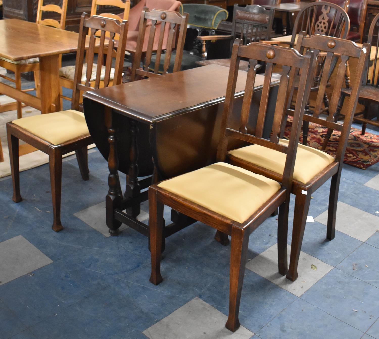 A Mid 20th Century Oak Drop Leaf Gate Legged Dining Table and Four Chairs