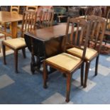 A Mid 20th Century Oak Drop Leaf Gate Legged Dining Table and Four Chairs