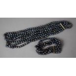 A Four Strand Black Tahitian Style Pearl Necklace and Bracelet Set