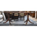 A Twin Pedestal Oval Mahogany Extending Dining Table with One Extra Leaf