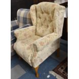 A Modern Upholstered and Buttoned Backed Wing Armchair