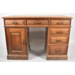 An Edwardian Oak Kneehole Writing Desk with Three Top Drawers, Kneehole flanked by Three Graduated