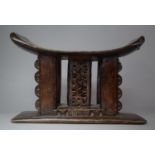 A 19th Century African Ashanti Carved Wooden Stool with Pierced Decoration, 42cm wide