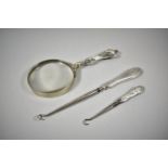 A Silver Handled Magnifying Glass and Two Silver Handled Button Hooks